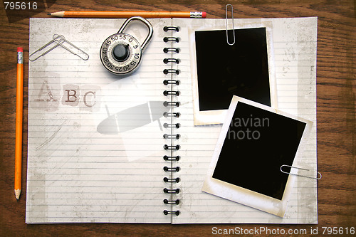 Image of White copy book, pencils and photos