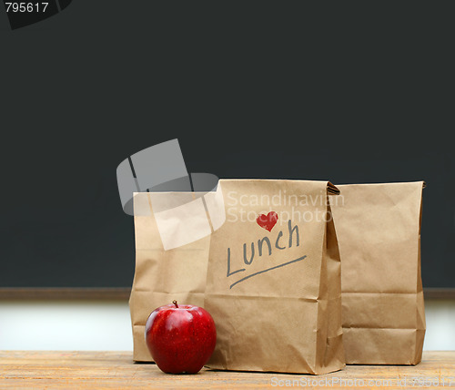 Image of Lunch bags with  apple on school desk