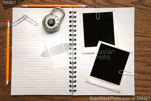 Image of White copy book, pencils and polaroids