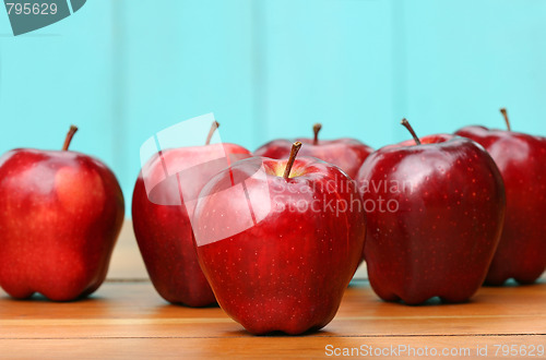 Image of Red delicious apples on old school desk