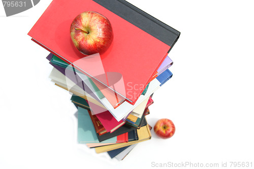 Image of Large piles of books with apples on white