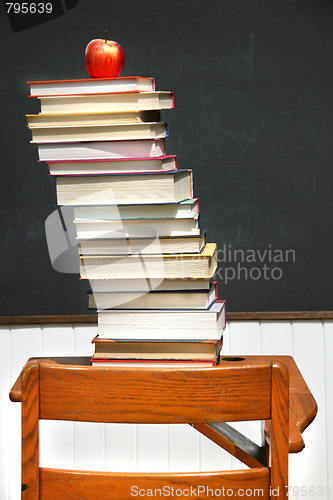 Image of Stack of books on an old school desk 