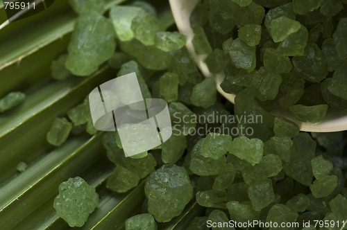 Image of bath salt and palm leaf