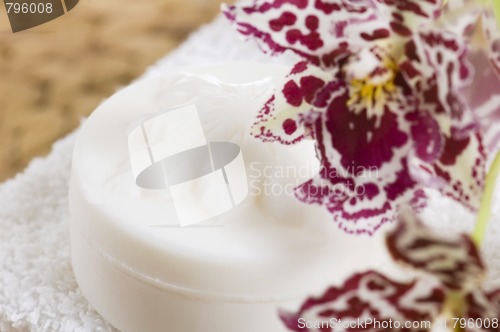 Image of Spa items with white towels, natural soap and orchid