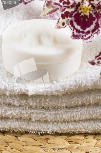 Image of Spa items with white towels, natural soap and orchid