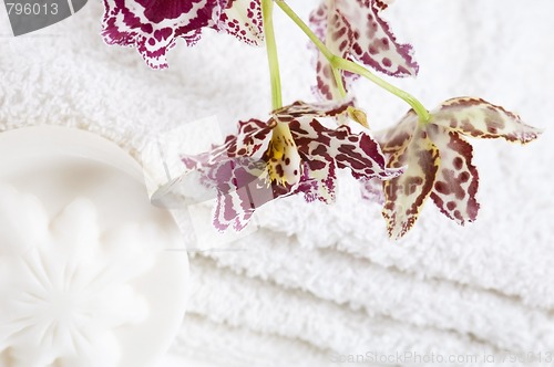 Image of Spa items with white towels, natural soap and orchid