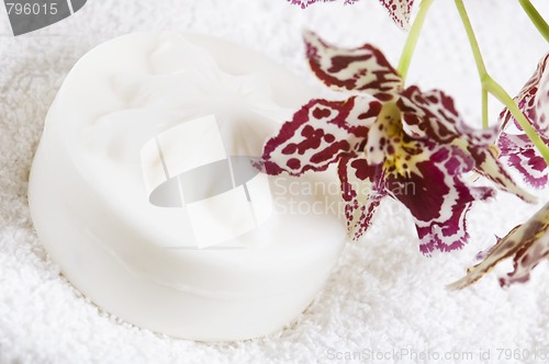 Image of Spa items with white towels, natural soap and orchid