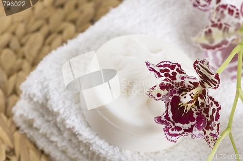 Image of Spa items with white towels, natural soap and orchid