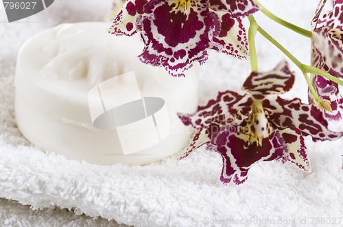 Image of Spa items with white towels, natural soap and orchid
