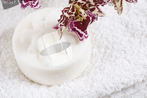 Image of Spa items with white towels, natural soap and orchid