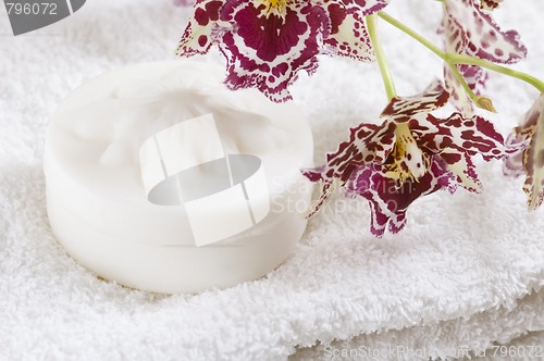 Image of Spa items with white towels, natural soap and orchid