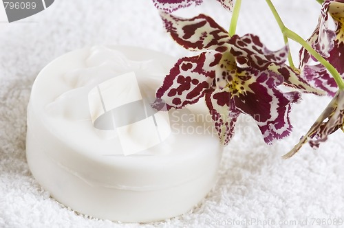 Image of Spa items with white towels, natural soap and orchid