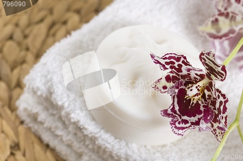 Image of Spa items with white towels, natural soap and orchid