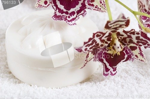 Image of Spa items with white towels, natural soap and orchid