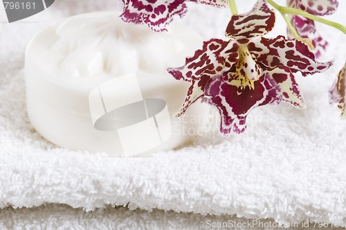 Image of Spa items with white towels, natural soap and orchid