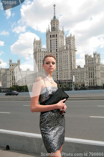 Image of serious girl with hand-bag