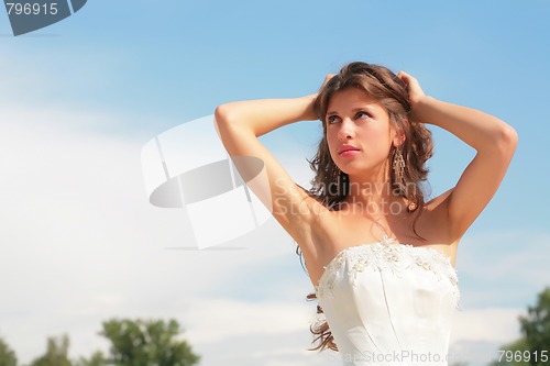 Image of pretty woman on background blue sky