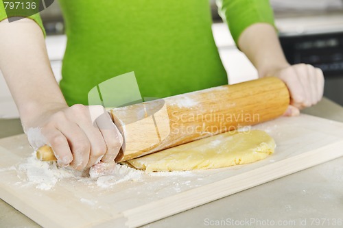 Image of Hands with rolling pin and cookie dough