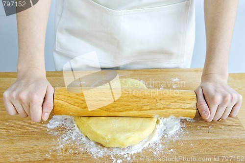 Image of Hands with rolling pin and cookie dough