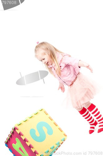 Image of Little girl playing with cube