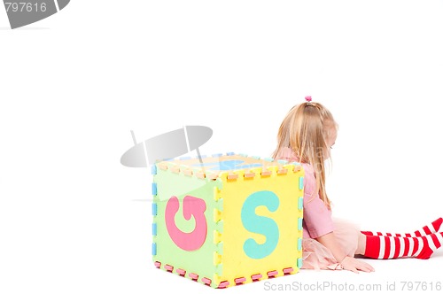 Image of Little girl playing with cube