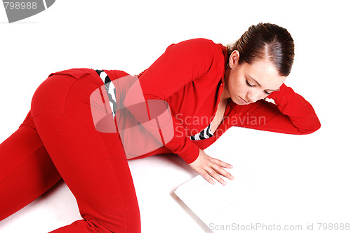 Image of Girl lying on floor and reading. 