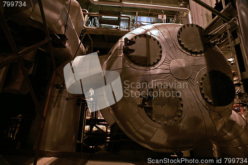 Image of Pipes, tubes, machinery and steam turbine at a power plant