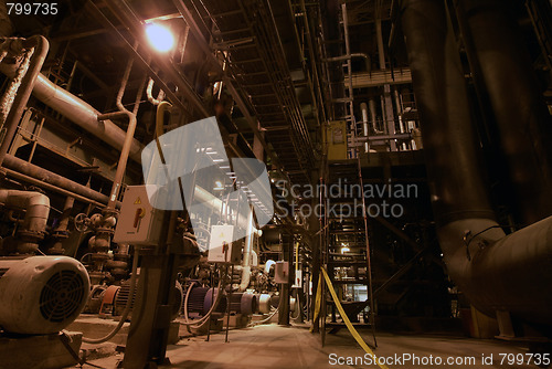 Image of Pipes, tubes, machinery and steam turbine at a power plant