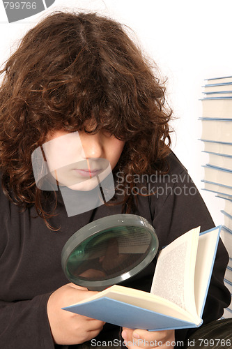 Image of boy reading a book with lens