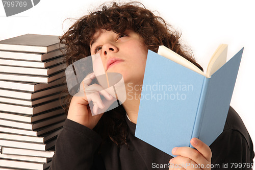 Image of boy thinking and reading a book 