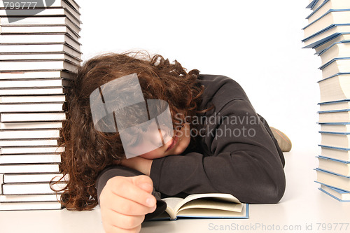 Image of boy sleeping and and many books 