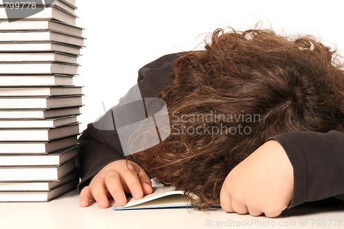 Image of boy sleeping and and many books 
