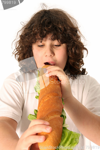 Image of boy eating large sandwich 