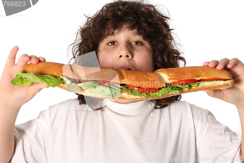 Image of boy eating large sandwich 