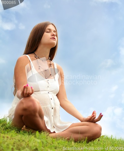 Image of expectant mother is meditating