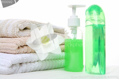 Image of shampoo, towel and aromatic oil