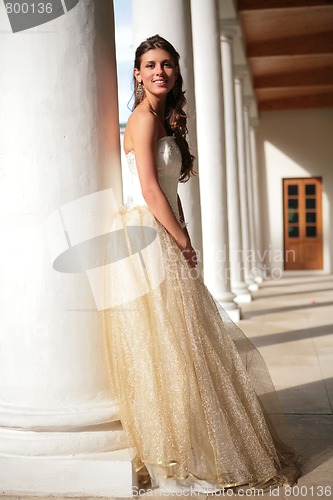 Image of smiling princess in white-golden gown in gallery