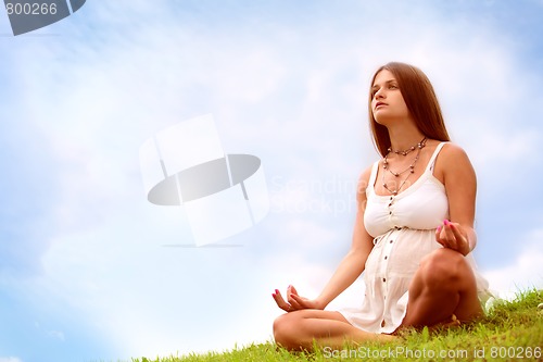 Image of expectant mother is meditating