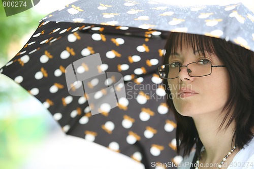 Image of beautiful woman under summer rain