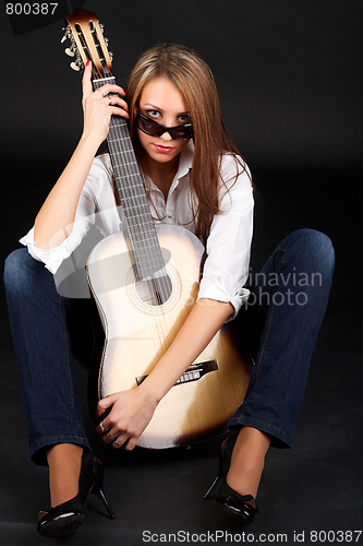 Image of Woman with guitar.