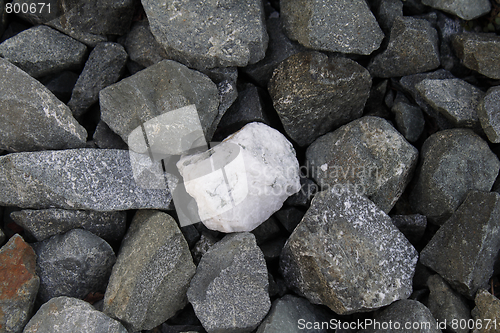 Image of White stone among gray ones