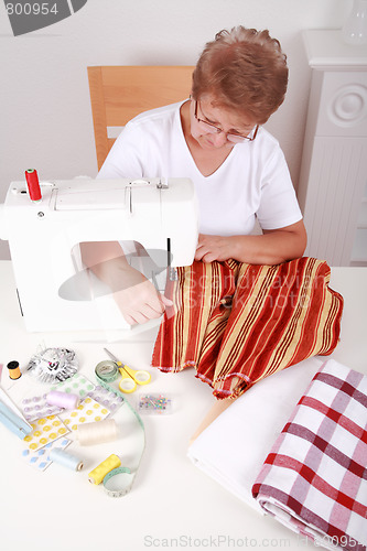 Image of Elderly woman sewing