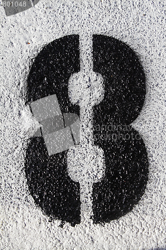Image of Number eight on asphalt