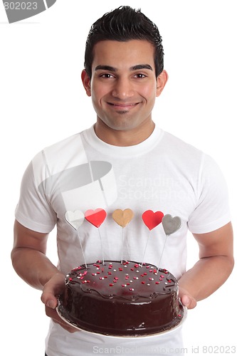Image of Man carrying romantic heart cake