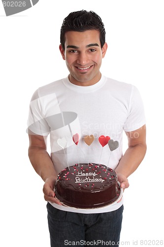 Image of Man carrying chocolate cake decorated with hearts