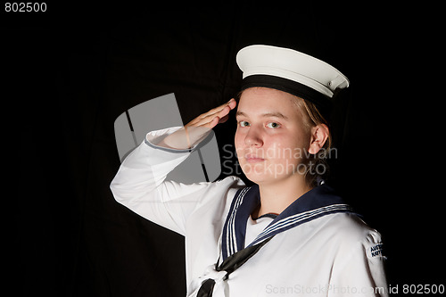 Image of navy seaman saluting on black
