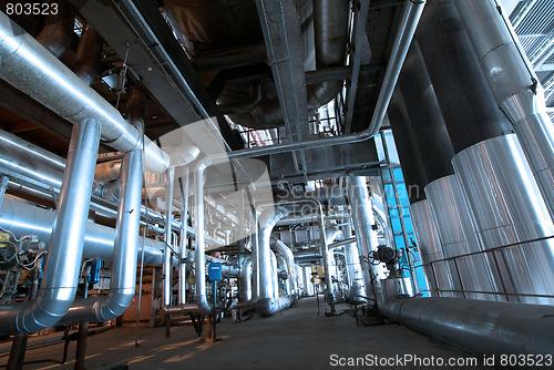 Image of Pipes, tubes, machinery and steam turbine at a power plant