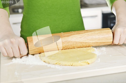 Image of Hands with rolling pin and cookie dough