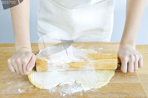 Image of Hands with rolling pin and cookie dough