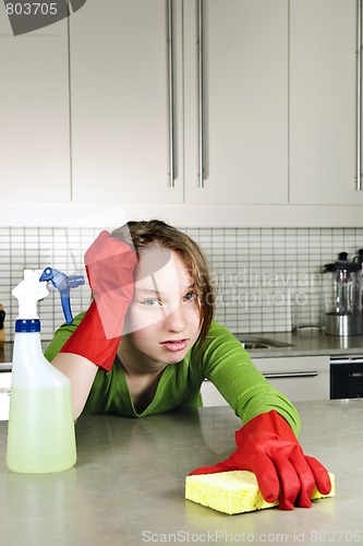 Image of Tired girl cleaning kitchen